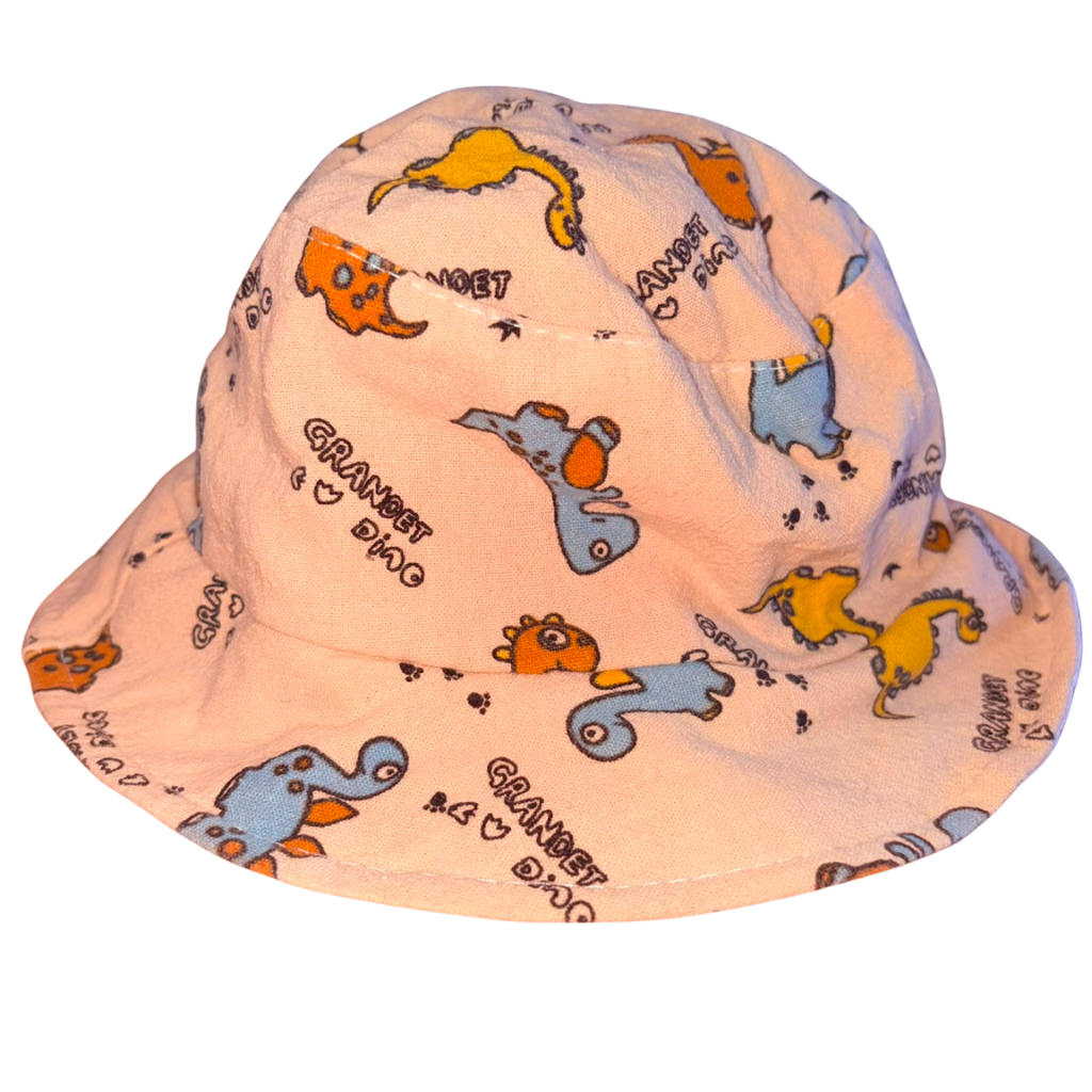 Gorro color beige con diseño de dinosaurios