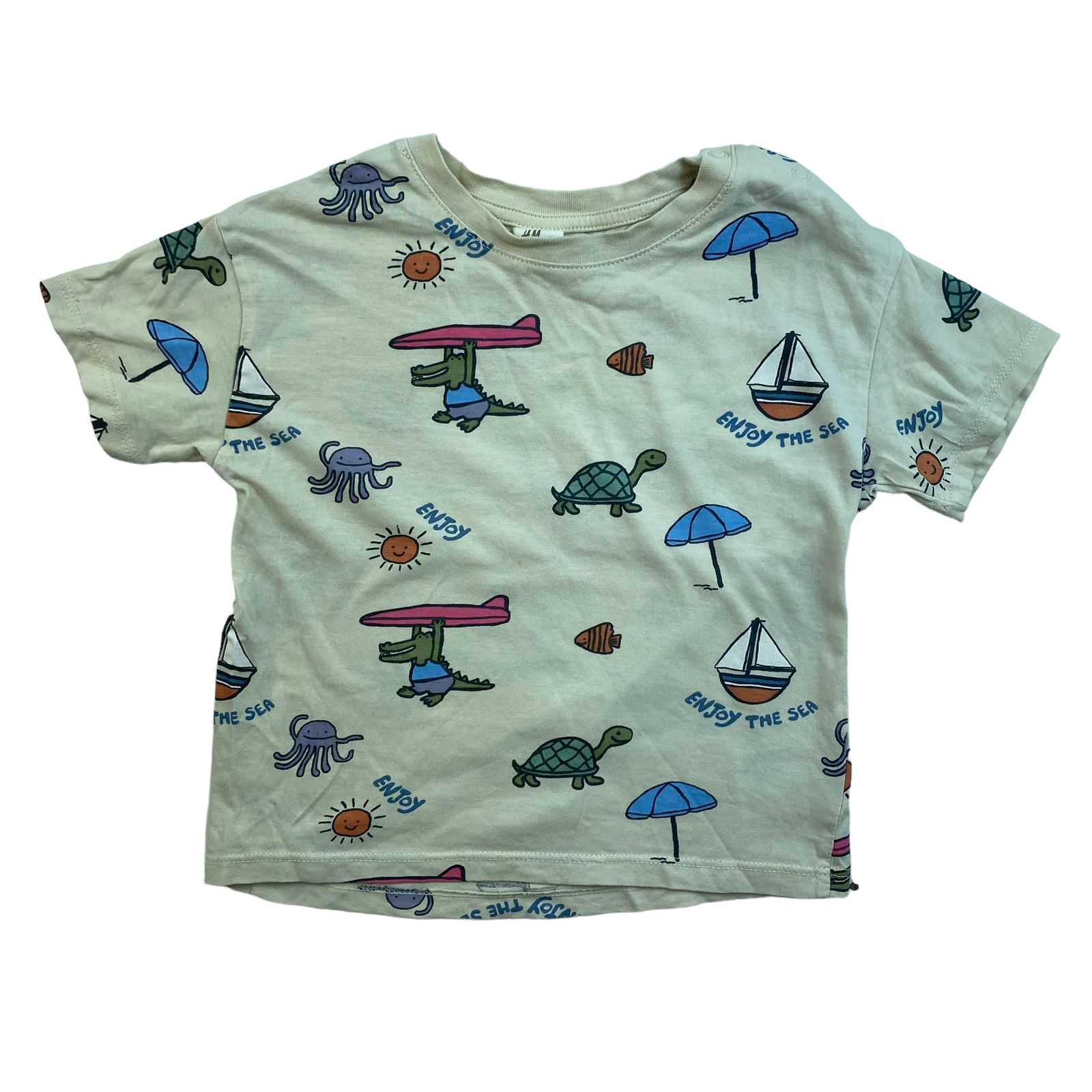 Polera beige con tortugas cocodrilos y peces